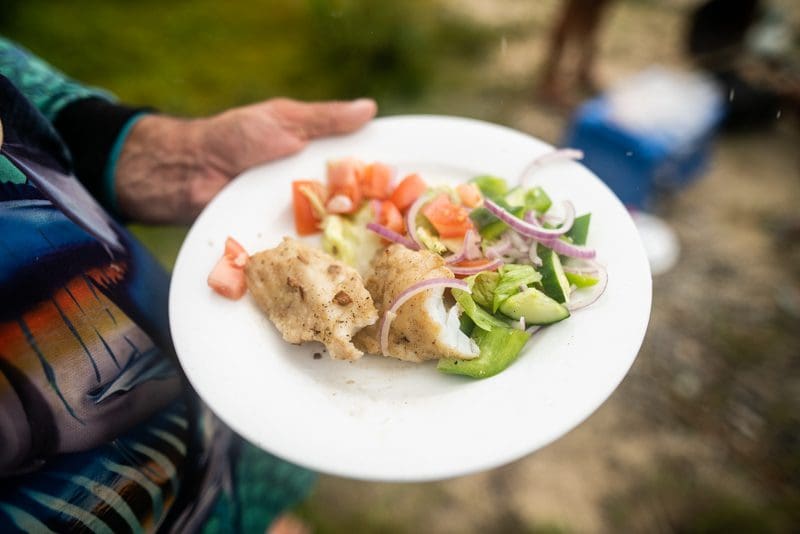 Garlic butter trout with salad on the plate