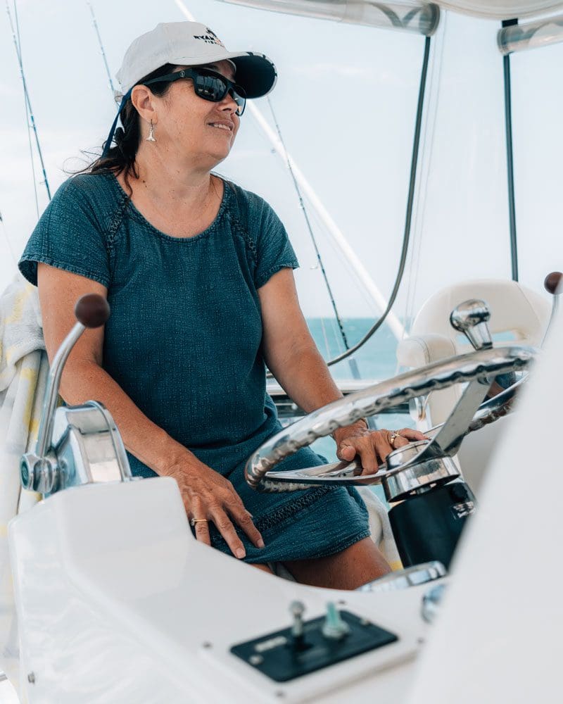 Woman driving boat.