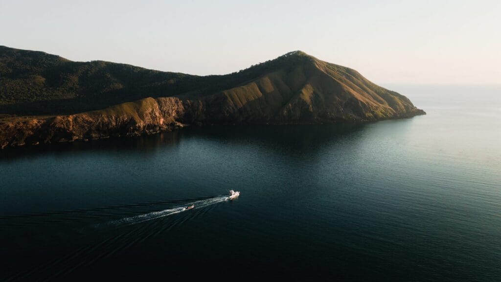 Boat near mountains at sunrise