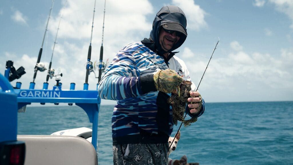 Fisherman with wire netting cod fishing beside the green zone