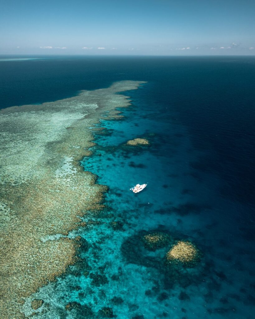 Boat at anchor near reef. 