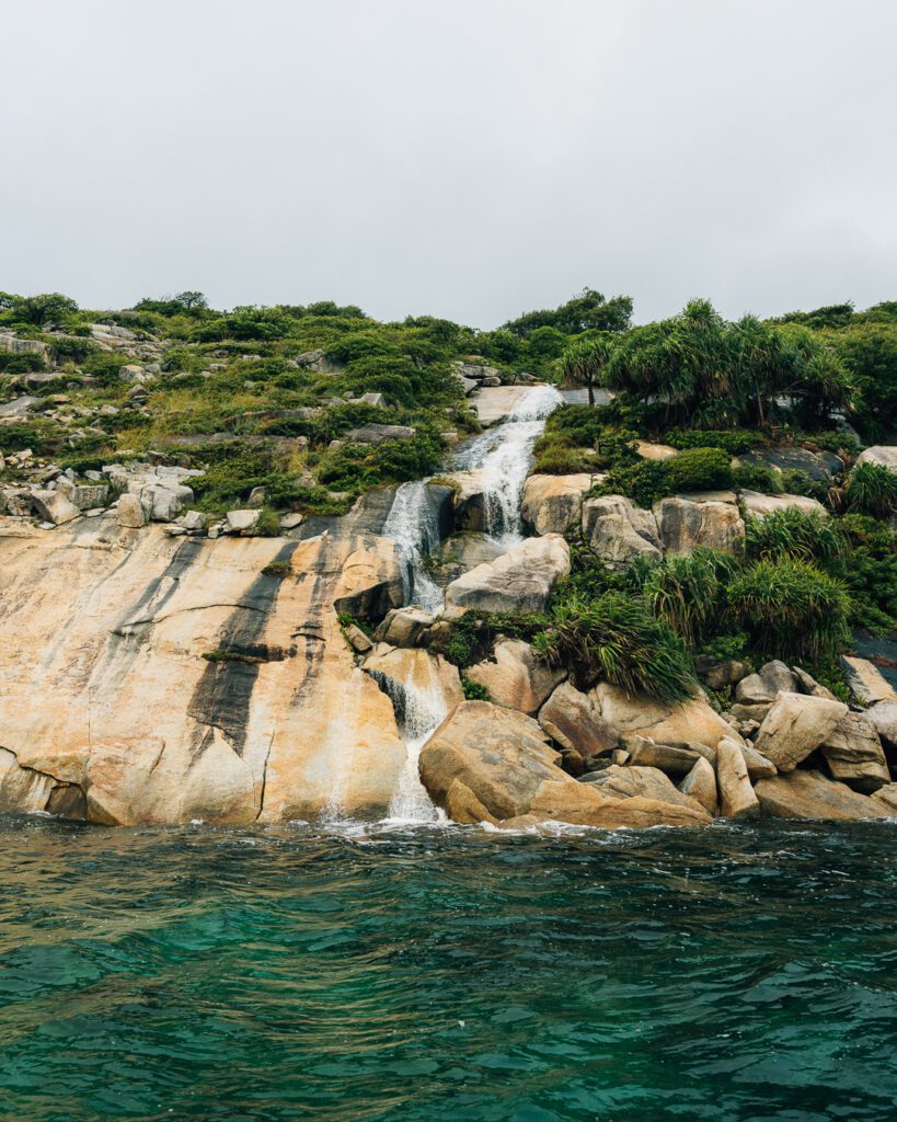 Waterfall from island rocks into the sea