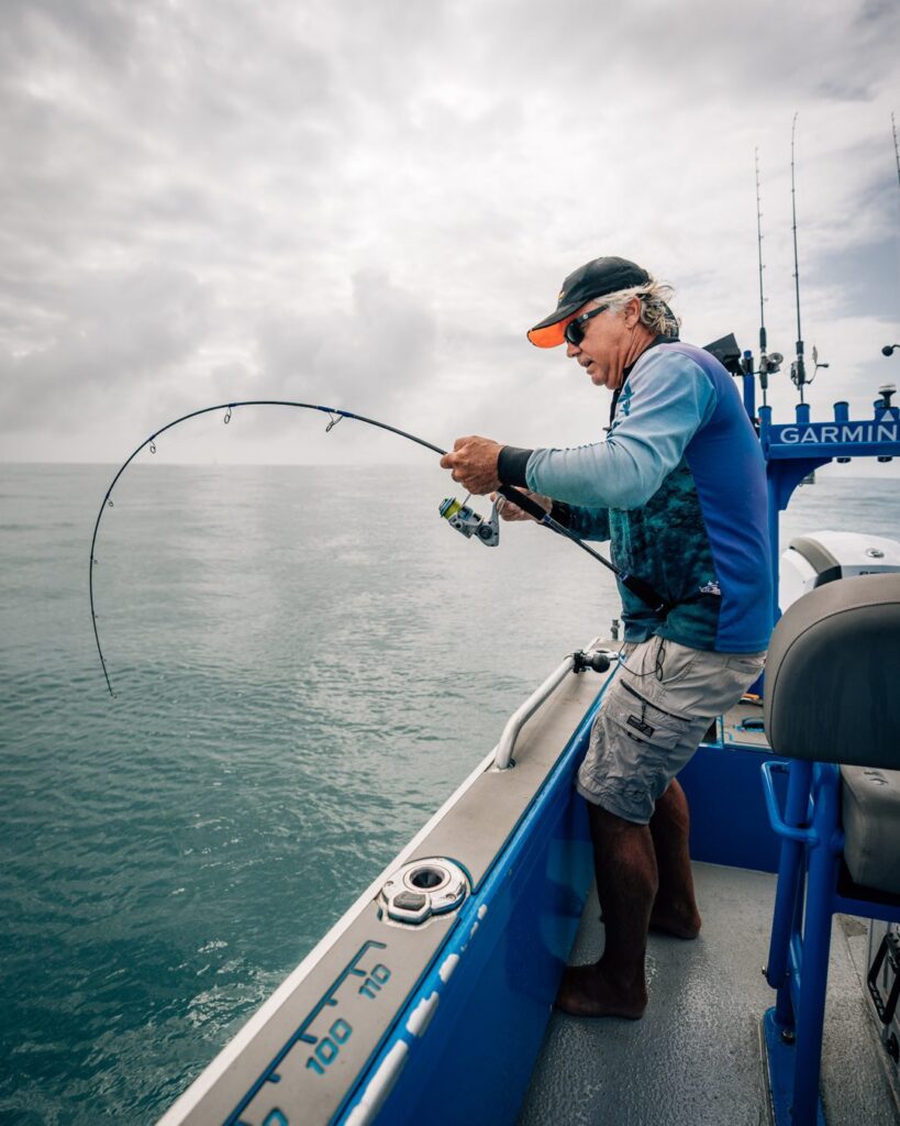 Angler fighting a big fish using Pillager sinking stick bait lure